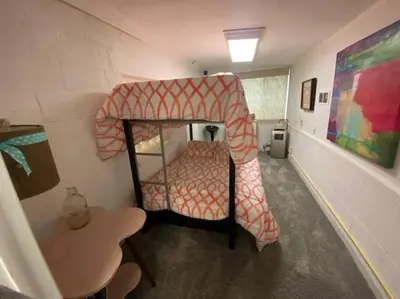 a room with a bunk bed and a table at Adorable Buckeye Lake Cottage in Buckeye Lake