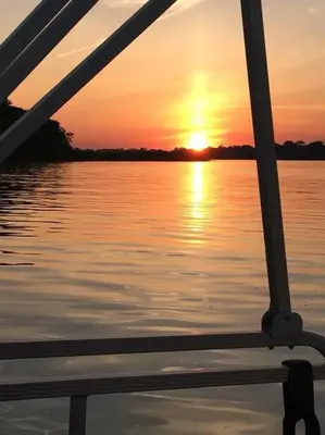 a view of the sunset from the front of a boat at Adorable Buckeye Lake Cottage in Buckeye Lake