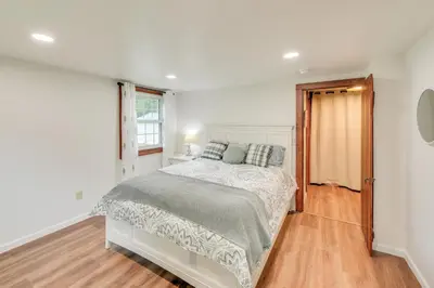 a white bedroom with a bed and a window at Peaceful Hiram Retreat on Cuyahoga River! in Aurora