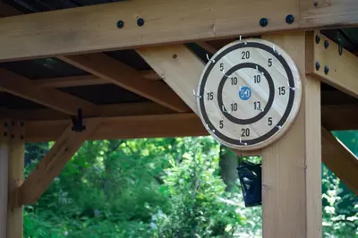 a clock is hanging on a wooden structure at Mohican Hideaway in Brinkhaven