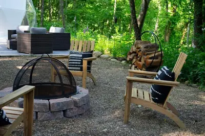 a group of chairs sitting around a fire pit at Mohican Hideaway in Brinkhaven