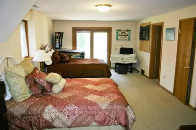 a large bedroom with two beds and a lamp at Portage Lakes Serenity in Akron