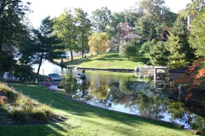 a river with boats parked on the side of it at Portage Lakes Serenity in Akron