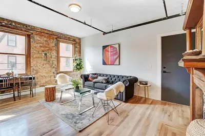 a living room with a couch and a table at Vaughn Lofts # 4 in Cincinnati