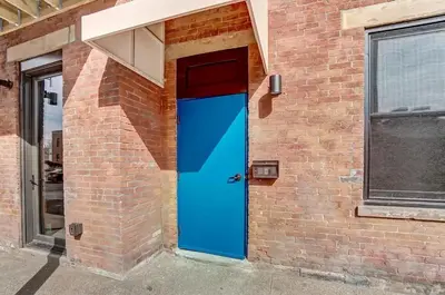a blue door on the side of a brick building at Vaughn Lofts # 4 in Cincinnati