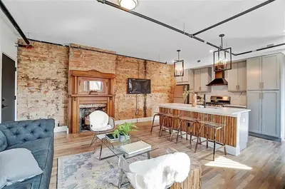 a kitchen and living room with a couch and a table at Vaughn Lofts # 4 in Cincinnati