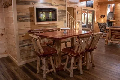 a dining room with a wooden table and chairs at Hickory Ridge Cabin+Fire pit in Ewing