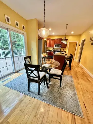 a living room with a table and chairs and a kitchen at Redbud Retreat in Centerville