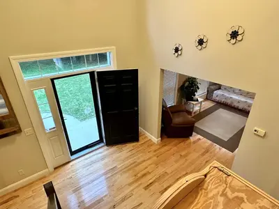 an empty living room with a door and a chair at Redbud Retreat in Centerville