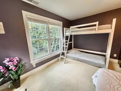 a bedroom with two bunk beds and a window at Redbud Retreat in Centerville