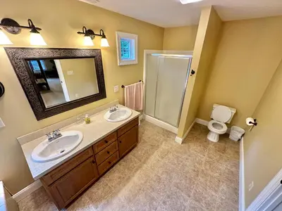 a bathroom with two sinks and a shower at Redbud Retreat in Centerville