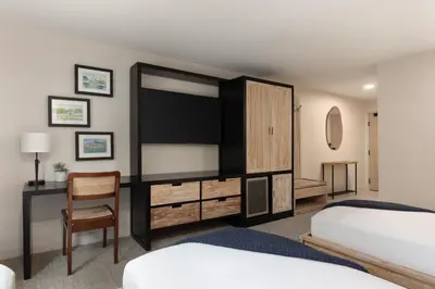 a bedroom with two beds and a flat screen tv at The Wave at Marblehead in Marblehead