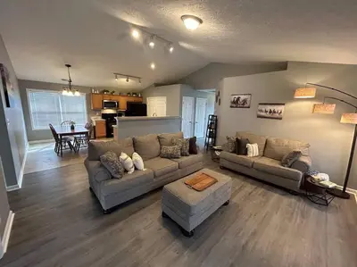 a living room with two couches and a kitchen at Kentucky - It's Natural! in Georgetown
