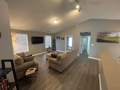 a living room with two couches and a flat screen tv at Kentucky - It's Natural! in Georgetown