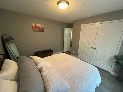 a bedroom with a white bed and a white door at Kentucky - It's Natural! in Georgetown