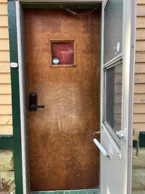 a wooden door with a picture on top of it at Stay with Jay - Segunda Room in Cleveland