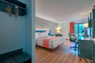 a hotel room with a bed and a desk at Motel 6 Walton, KY - Richwood - Cincinnati Airport South in Walton