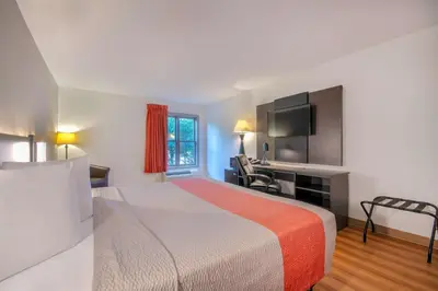 a hotel room with a bed and a desk at Motel 6 Walton, KY - Richwood - Cincinnati Airport South in Walton