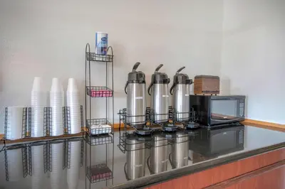 a kitchen counter with a bunch of silver condiments at Motel 6 Walton, KY - Richwood - Cincinnati Airport South in Walton
