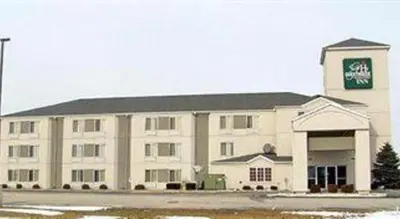a large white building with a sign on it at Hotel Markle IN I-69 in Markle