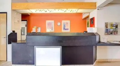 a counter in a room with an orange wall at Hotel Markle IN I-69 in Markle