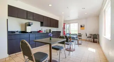 a kitchen with a table and chairs in a room at Hotel Markle IN I-69 in Markle