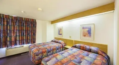a hotel room with two beds and a window at Hotel Markle IN I-69 in Markle