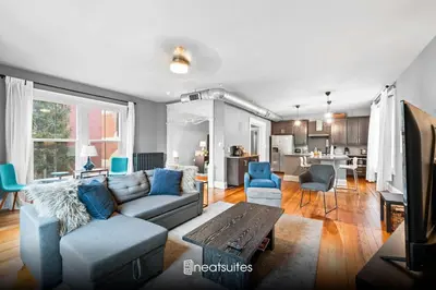 a living room with a couch and a table at 1BR - Walk to Convention Center & Stadiums in Ludlow