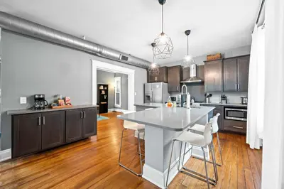 a kitchen with a white table and chairs in it at 1BR - Walk to Convention Center & Stadiums in Ludlow