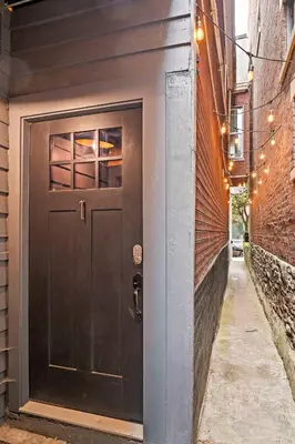 a black door on the side of a building at 1BR - Walk to Convention Center & Stadiums in Ludlow