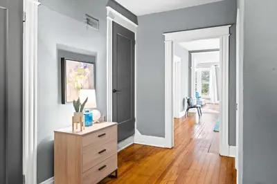 a room with a dresser with a vase of flowers on it at 1BR - Walk to Convention Center & Stadiums in Ludlow