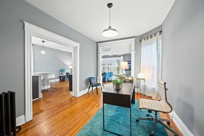 a living room with a desk and a dining room at 1BR - Walk to Convention Center & Stadiums in Ludlow