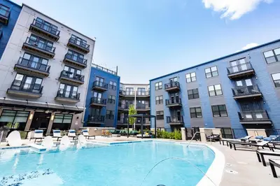 a large swimming pool in front of some buildings at 2 Stylish apartments near shops and entertainment in Cincinnati