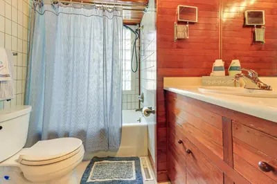 a bathroom with a toilet and a sink and a shower at Great Lake Erie Getaway with Hot Tub and Private Beach in Avalon Beach