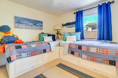 two beds in a room with a window at Great Lake Erie Getaway with Hot Tub and Private Beach in Avalon Beach