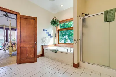 a bathroom with a tub and a shower stall at Great Lake Erie Getaway with Hot Tub and Private Beach in Avalon Beach