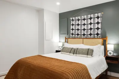 a bedroom with a large bed with a brown blanket at 4 Bed 3 bath Boutique Home Near OSU, Crew Stadium, Short North, COSI, & Downtown in Columbus