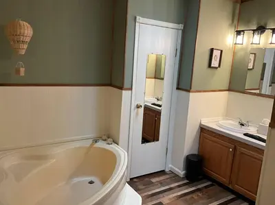 a bathroom with a large tub and a sink at Auburn in Chester