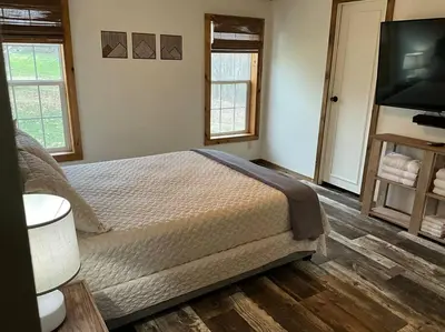 a bedroom with a bed and a flat screen tv at Auburn in Chester