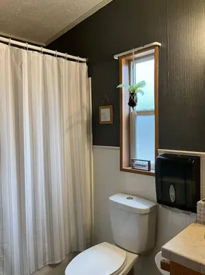 a bathroom with a white toilet and a window at Auburn in Chester