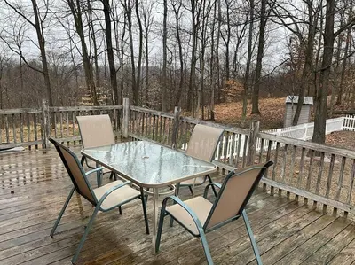 a glass table and chairs on a wooden deck at Auburn in Chester