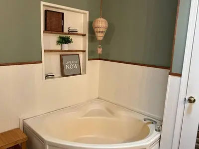 a bath tub in a bathroom with a sign on the wall at Auburn in Chester