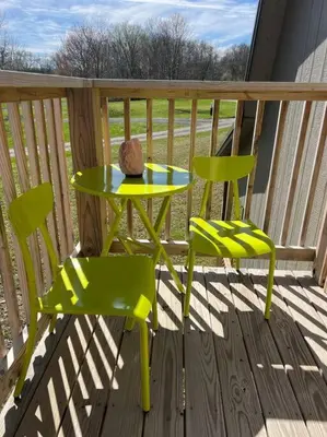 a green table and two chairs on a porch at Piedmont in Chester