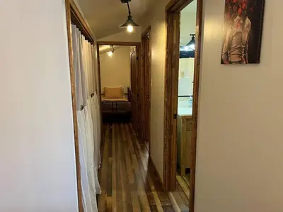 a hallway leading to a room with a mirror at Piedmont in Chester