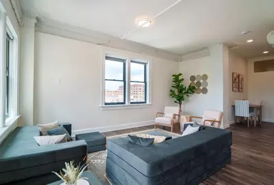 a living room with two couches and a table at The Standard Downtown Columbus in Columbus
