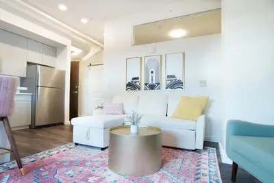 a living room with a white couch and a table at The Standard Downtown Columbus in Columbus