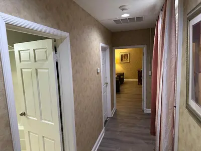 a hallway with a white door and a hallway with a room at Island House Historic Vacation Rentals in Port Clinton