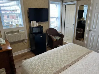 a hotel room with a bed and a tv and a televisionictericter at Island House Historic Vacation Rentals in Port Clinton