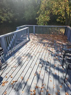 a deck with chairs and leaves on the ground at FC Suites in Cincinnati