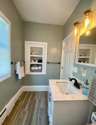 a bathroom with a sink and a window at Cozy Main Street Flat in Adrian